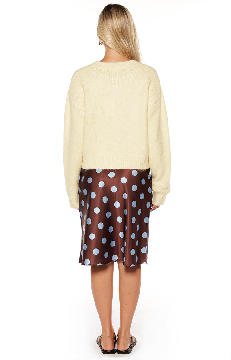 Rear view of a butter yellow fuzzy knit cardigan with long sleeves and a cropped ribbed hem