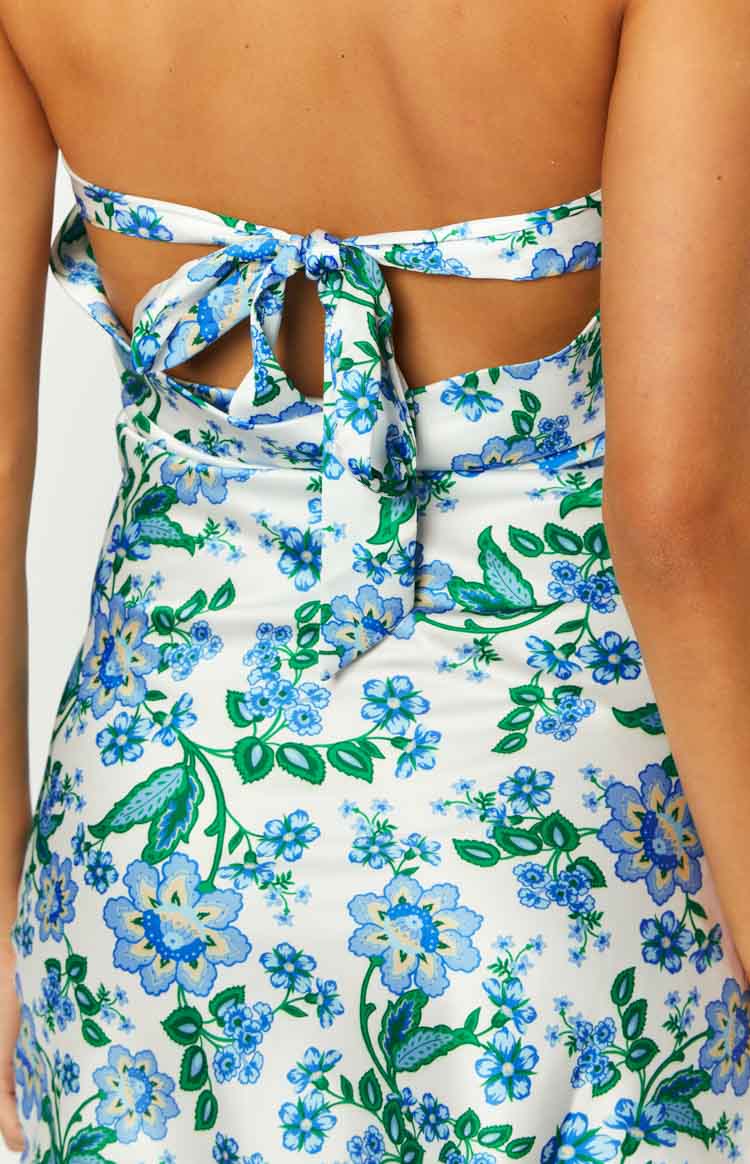 Close-up rear view of the white blue floral mini dress with a tie-back and open back cutouts