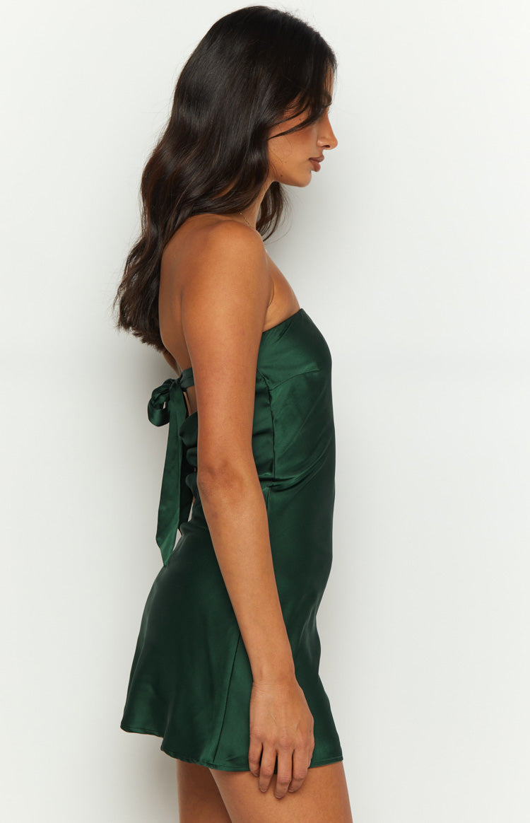 Side view of a forest green satin strapless mini dress with a tie-back detail