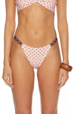 Front view of pink polka dot bikini bottoms with contrast brown waistband and high cut leg cute for the beach