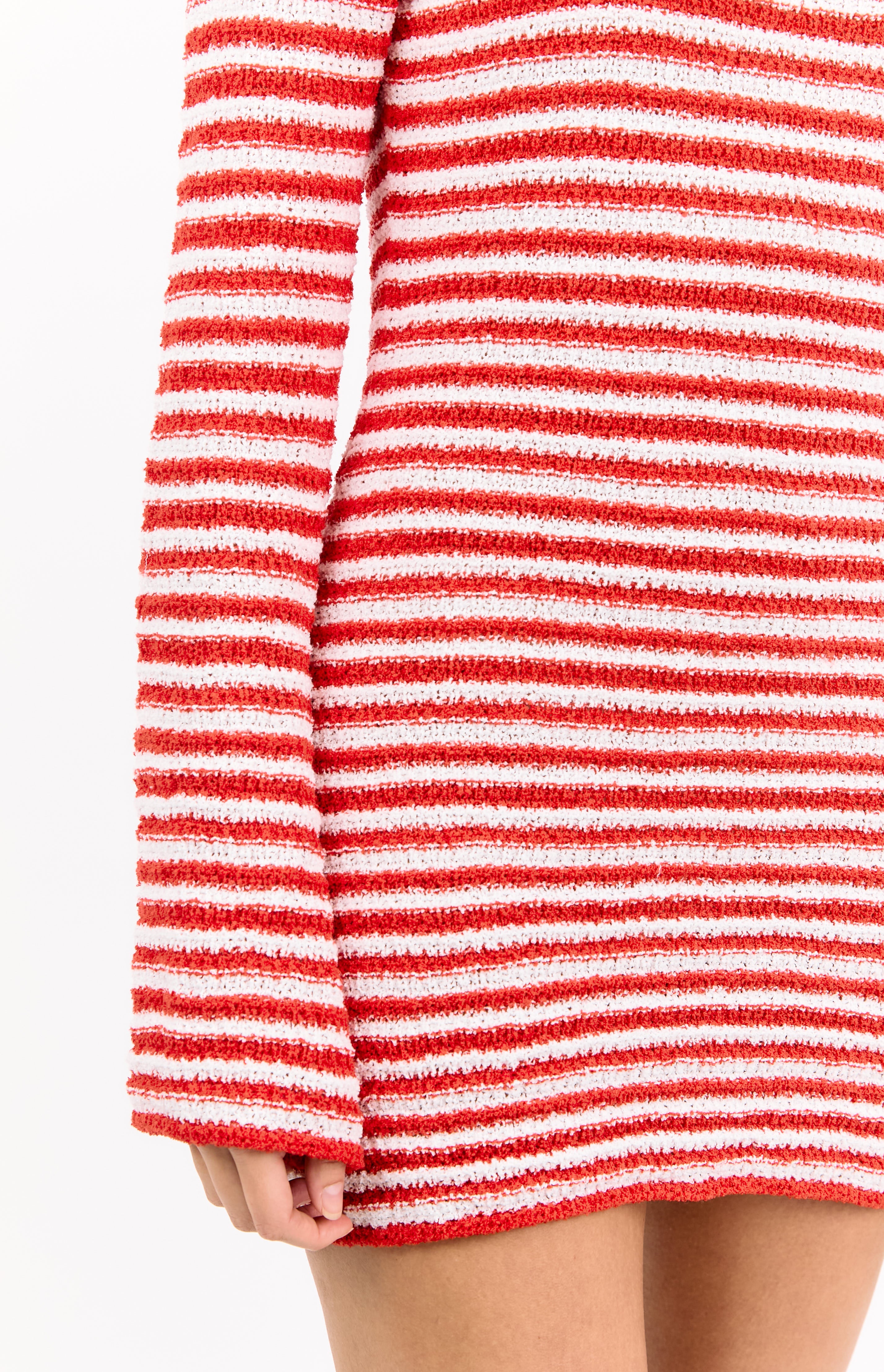 Close-up of the textured red and white striped knit fabric of the long sleeve mini dress