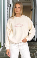 Front view of a cream crew neck sweater with a pink embroidered vintage car graphic