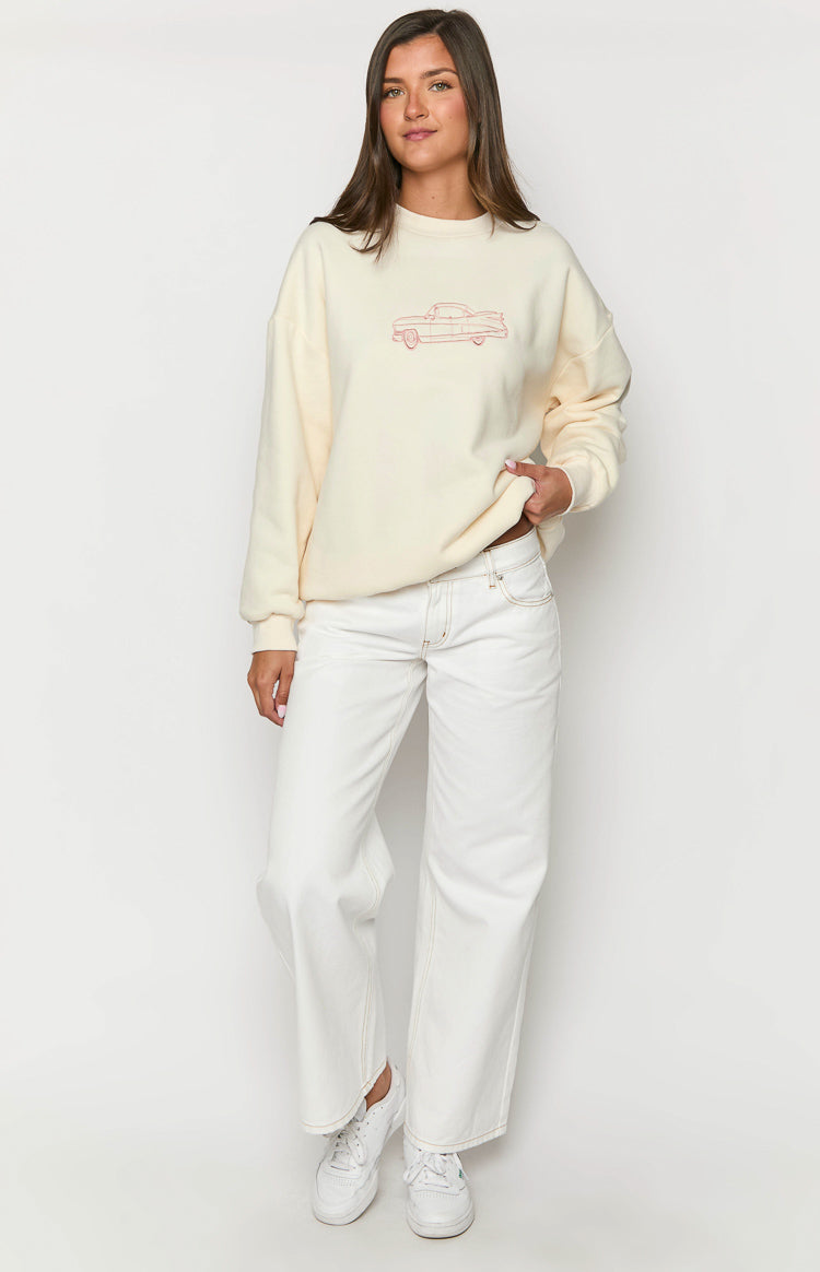 Cream oversized crew neck sweater with a red vintage car graphic on the front and long sleeves