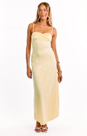 Our model in a yellow lace maxi dress with a sweetheart neckline and thin straps. This gorgeous formal gown features a sheer lace fabric over a yellow lining. An amazing dress for prom or a wedding guest.