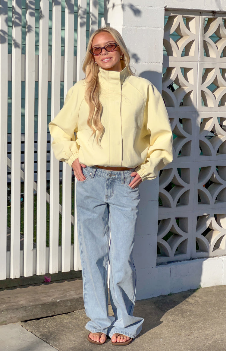 Yellow funnel neck sports jacket with a relaxed fit, long sleeves, elasticated cuffs and hem