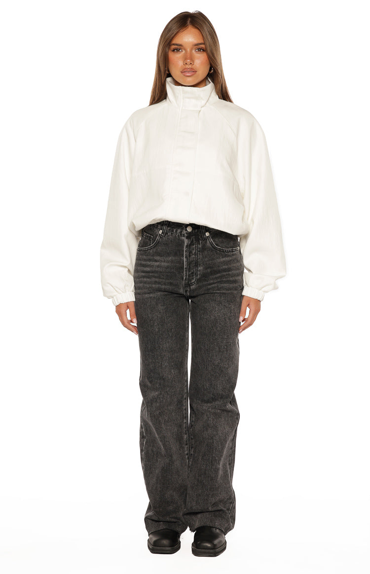 Front view of a cream textured funnel neck jacket with a relaxed fit, voluminous sleeves, and elasticated cuffs and hem