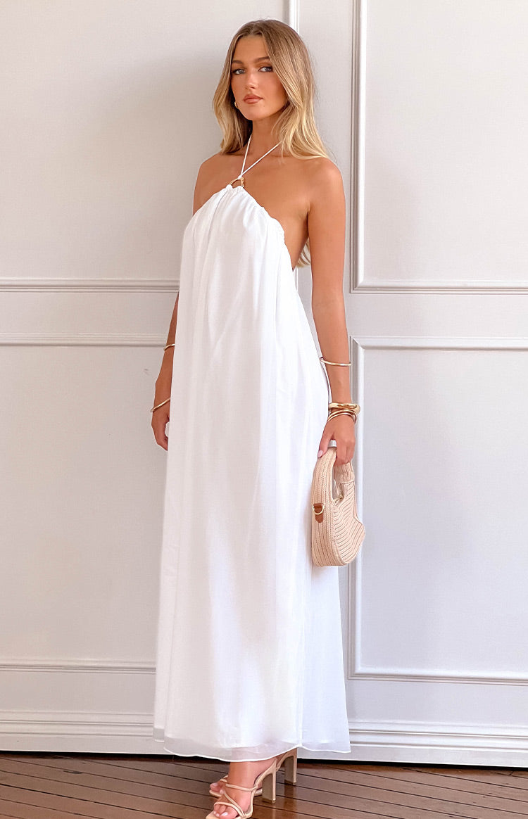 Front view of a white halter neck maxi dress with a gold ring detail at the neckline and a loose flowy fit