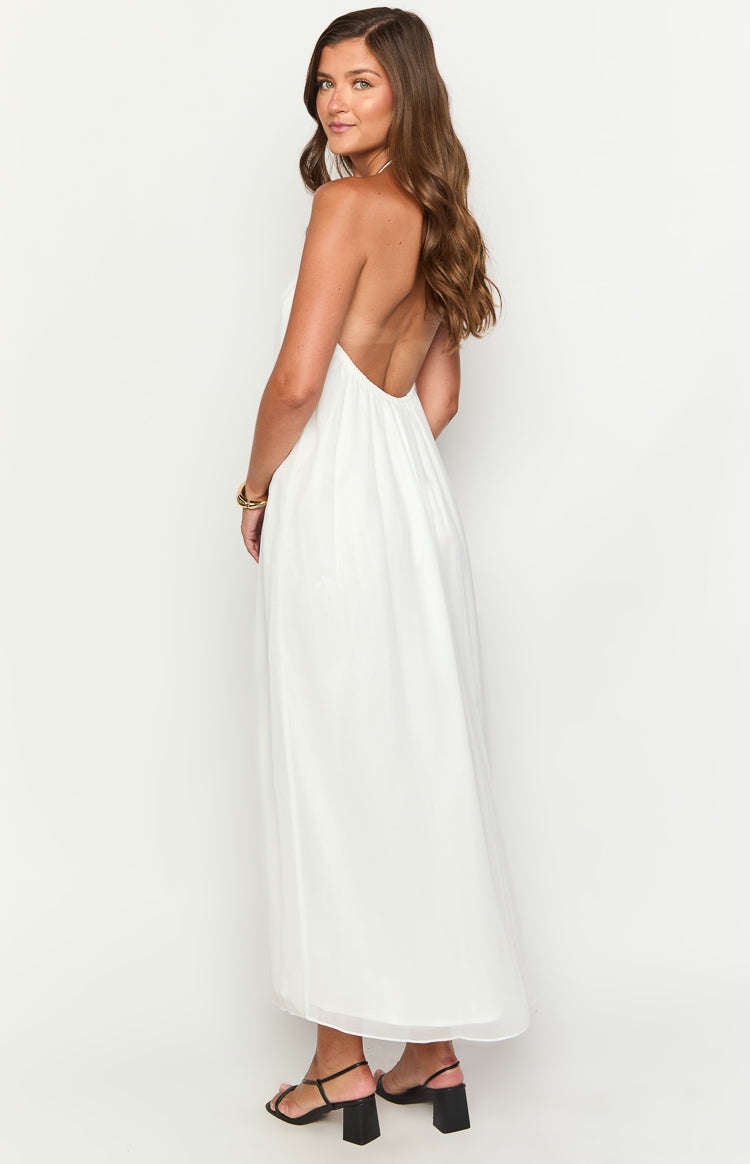 Side view of a white maxi dress with a low scoop back and a relaxed, flowing skirt