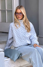 Close-up of the blue polka dot funnel neck sports jacket with elasticated cuffs and panel detailing