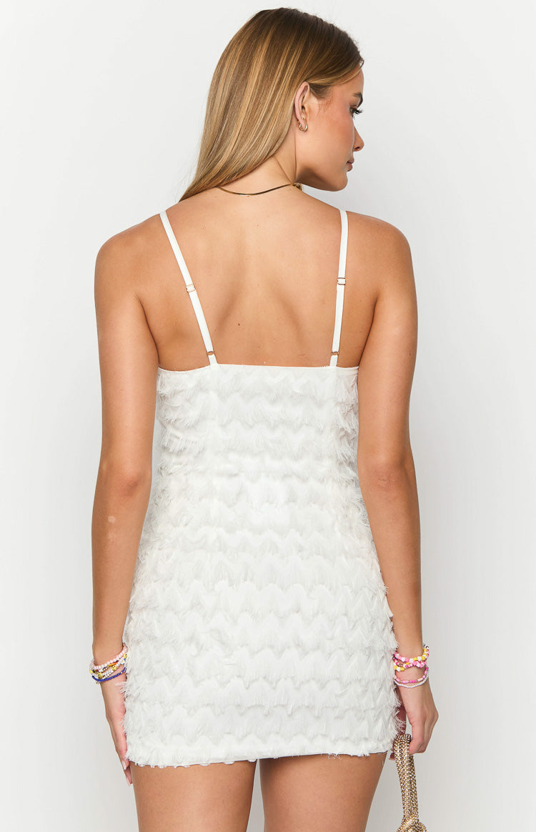 Rear view of a white mini dress with thin adjustable spaghetti straps and a textured chevron pattern