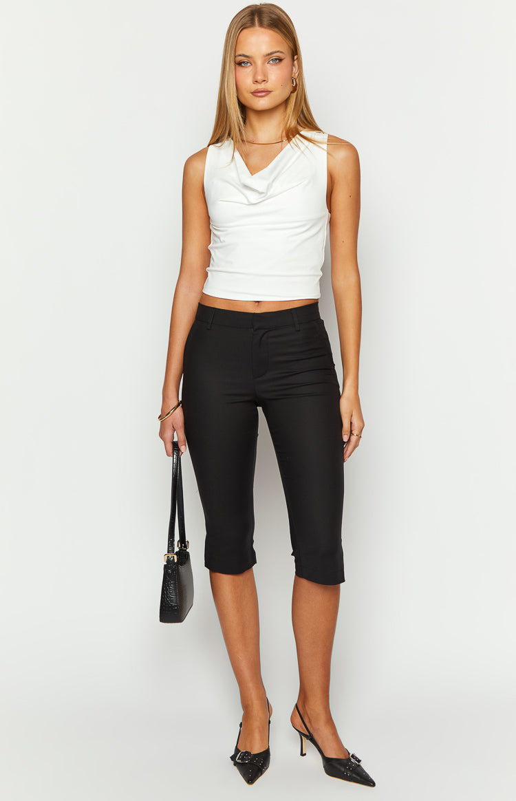 Front view of black fitted capri pants with a mid-rise waist and a clean, flat front
