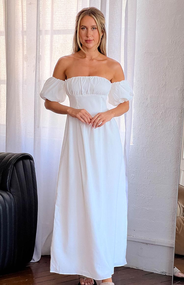 Full length front view of a white off-the-shoulder maxi dress with a shirred bodice and puff sleeves