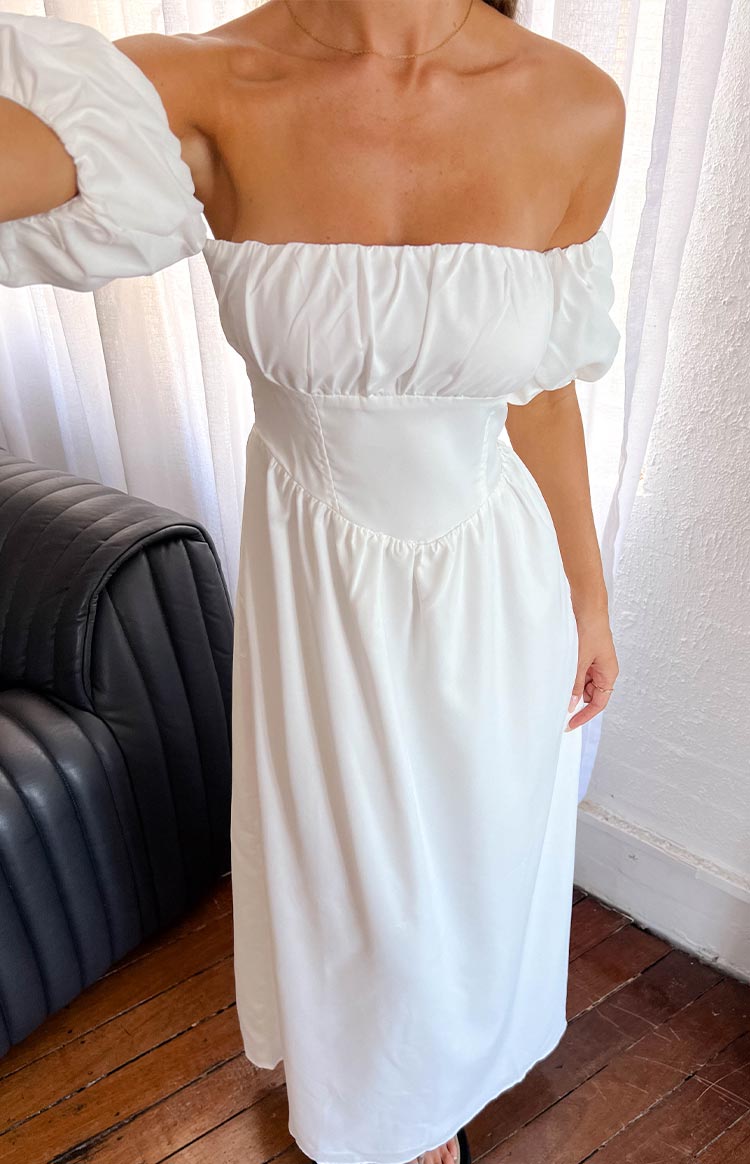 Close-up of the white off-the-shoulder maxi dress showing the fitted bodice and ruched neckline