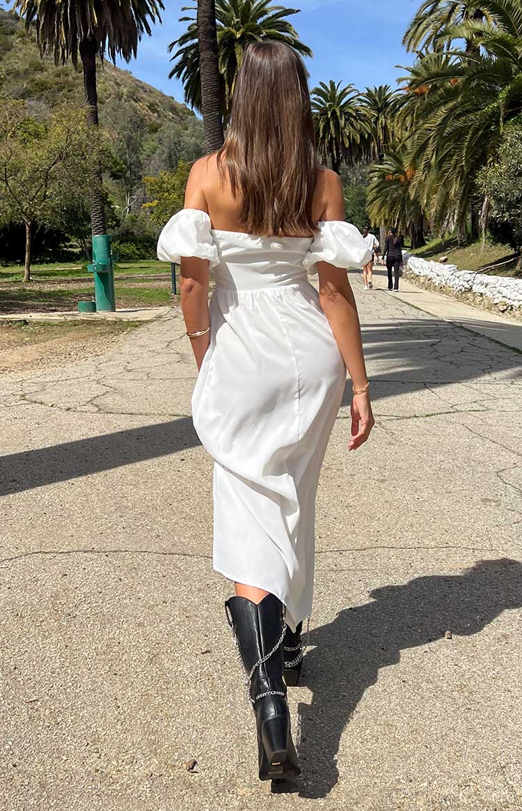 Rear view of a white off-the-shoulder maxi dress with puff sleeves and a fitted waist
