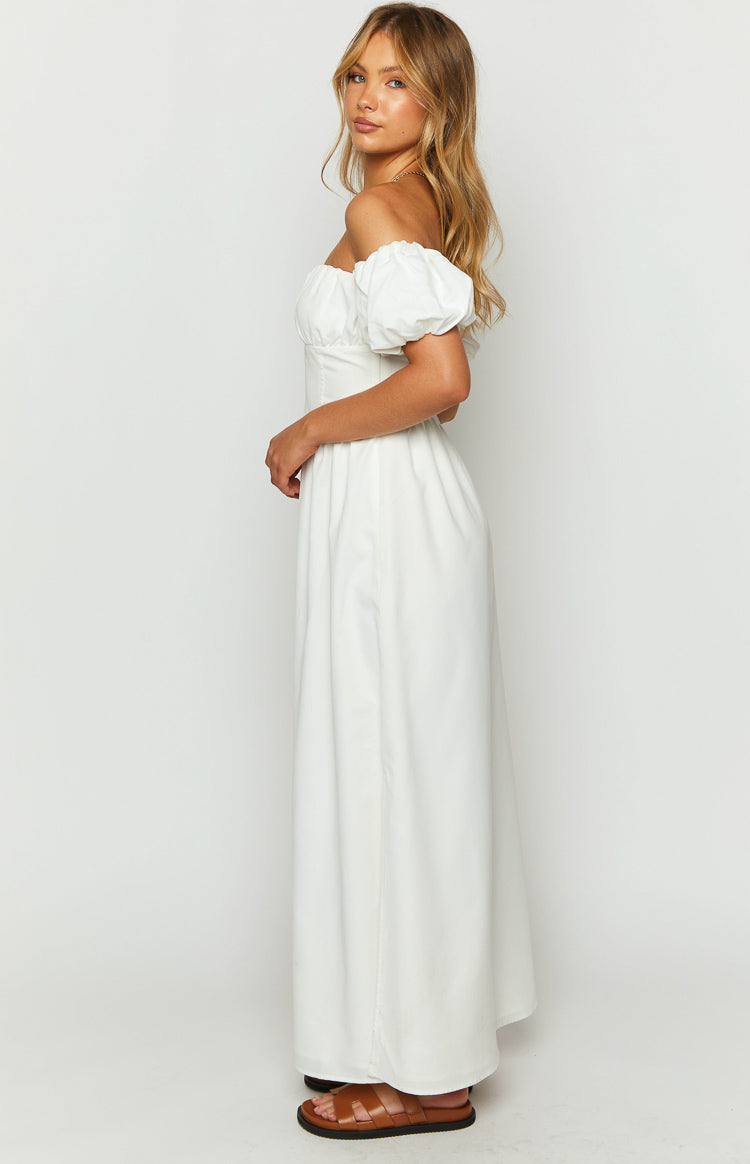 Side view of a white off-the-shoulder maxi dress with short puff sleeves and a flowing skirt