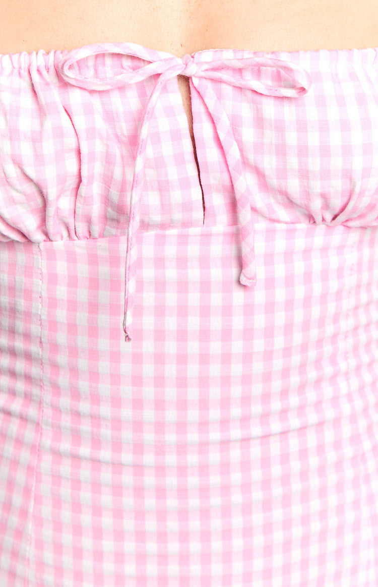 Detail shot of the pink gingham strapless mini dress showing the tie-front bust and keyhole