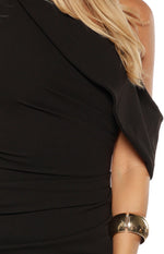 Close-up of the black crepe off-shoulder neckline with draped detail and ruched bodice