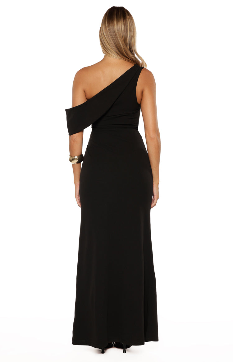 Back view of a black crepe maxi dress with an asymmetric one-shoulder strap and draped off-shoulder detail