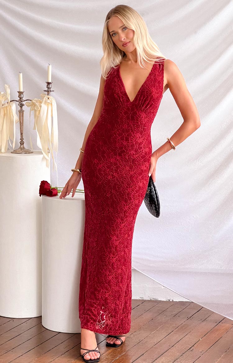 Red lace maxi dress with a deep V-neckline, sleeveless design, and intricate floral pattern