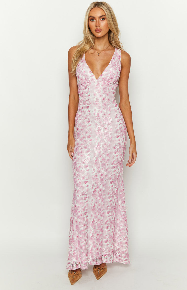 Pink floral lace maxi dress with a deep V-neckline and a fitted silhouette, flowing slightly at the hem