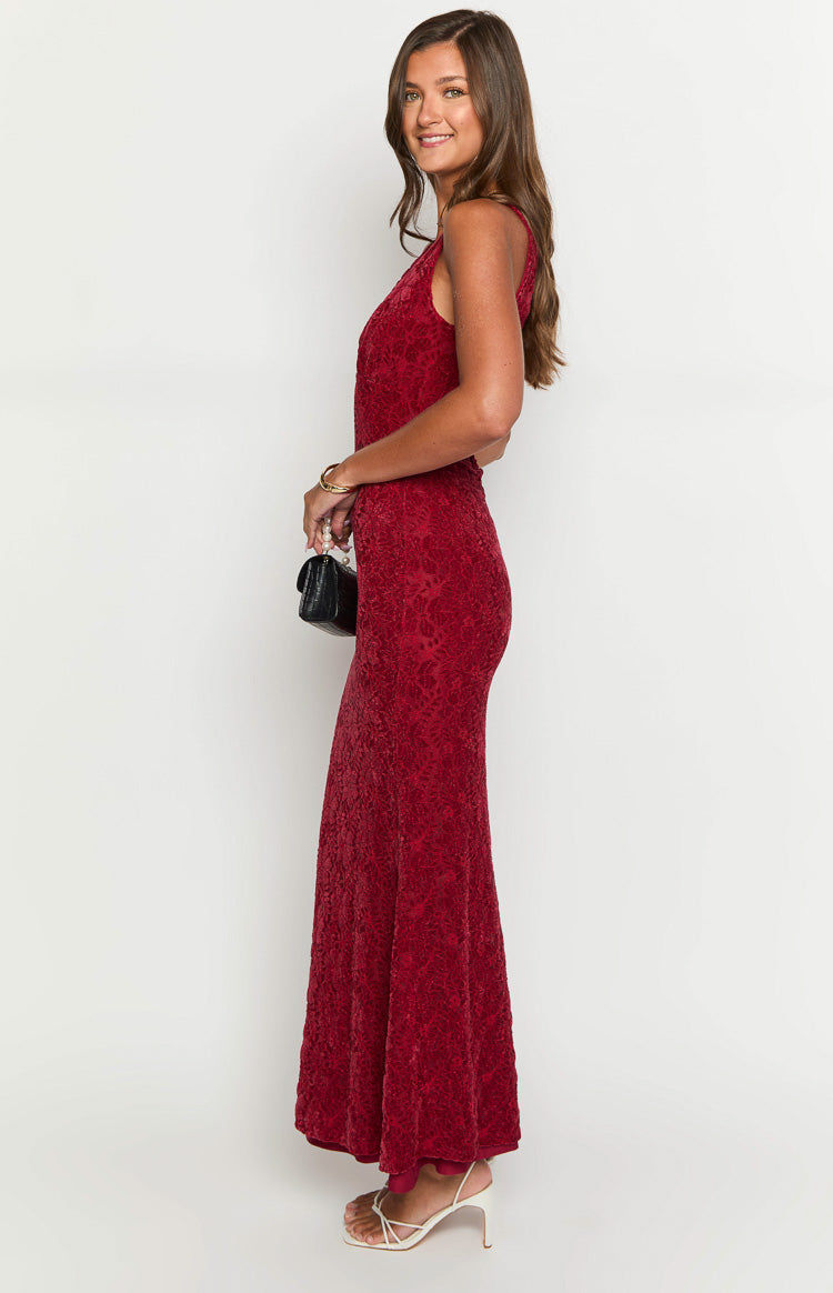 Side view of the red lace maxi dress, highlighting the fitted silhouette and subtle flared hem