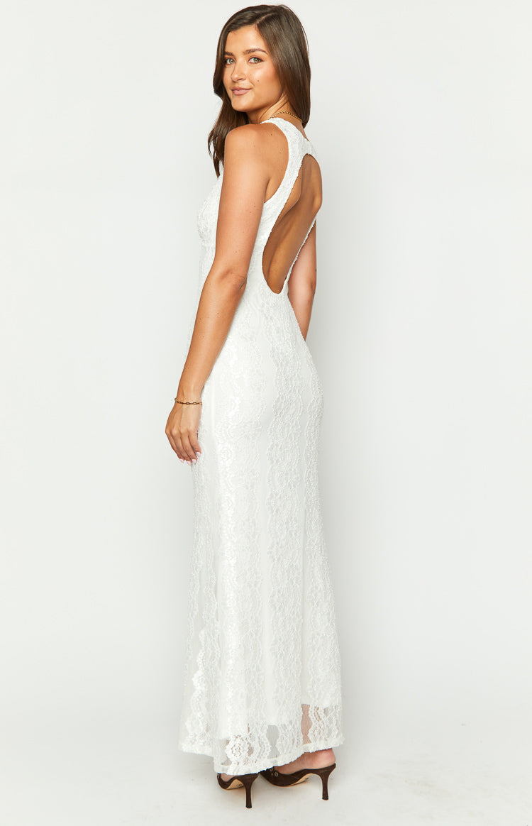 Side view of a white lace maxi dress with a low scoop open back and fitted silhouette
