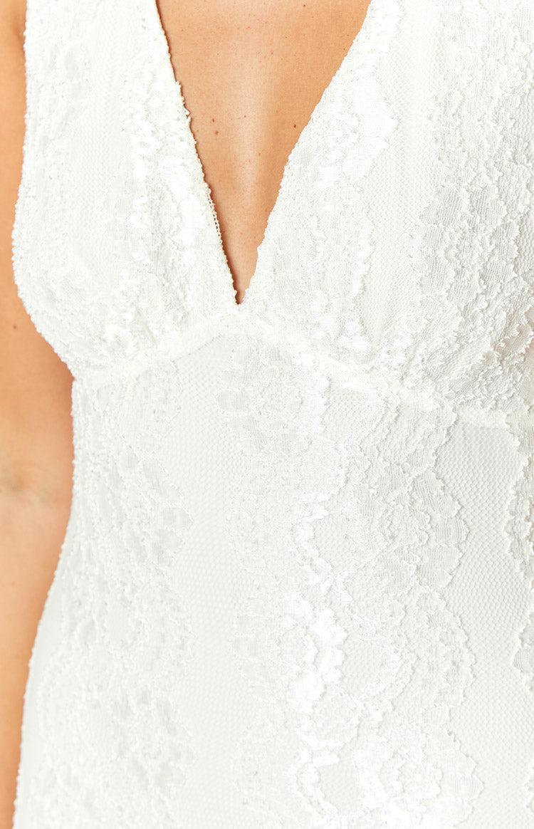 Close-up showing the delicate white floral lace pattern and deep V-neckline of the maxi dress bodice