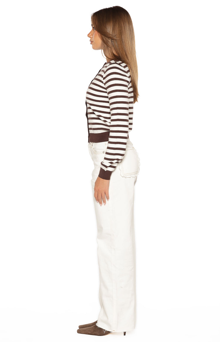 Side view of white straight leg denim jeans with scallop edge detail on the back pocket