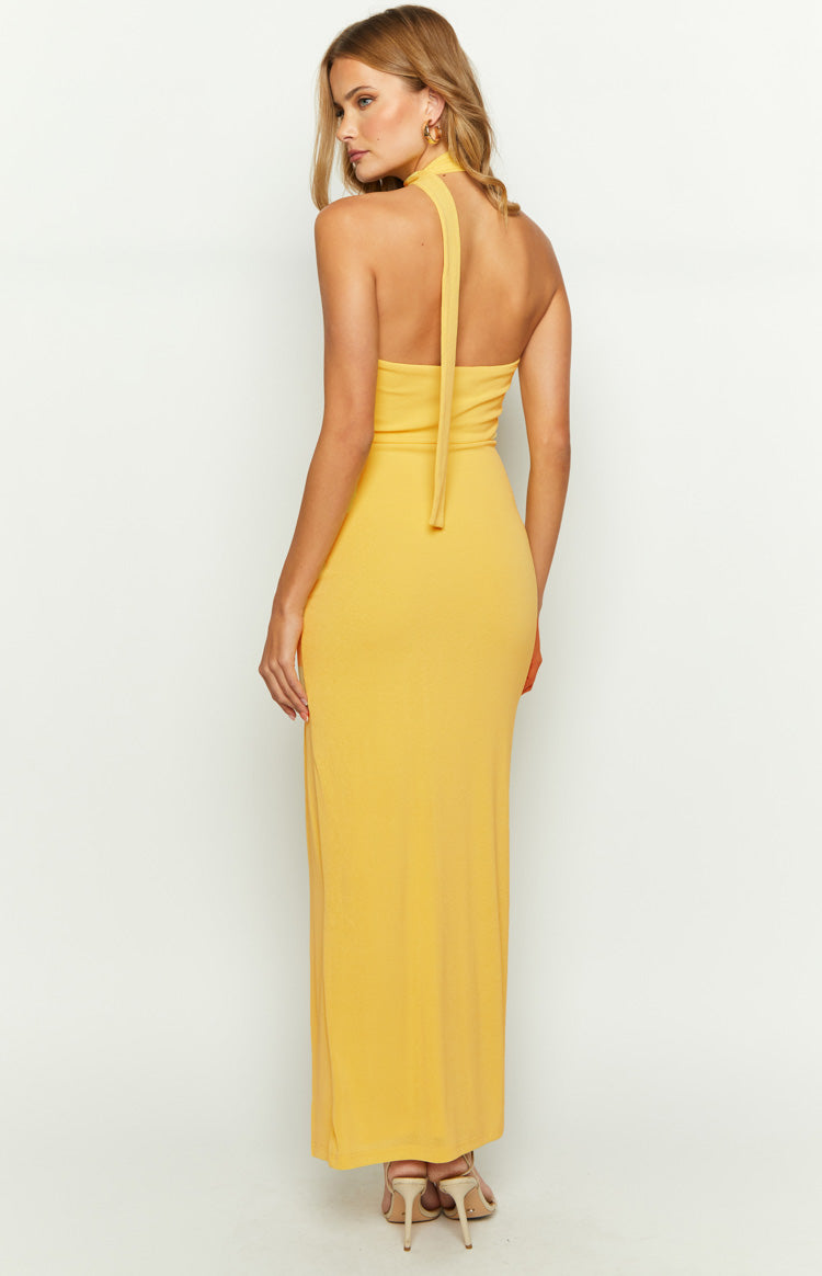 Rear view of a yellow maxi dress showing the halter neck tie and open back