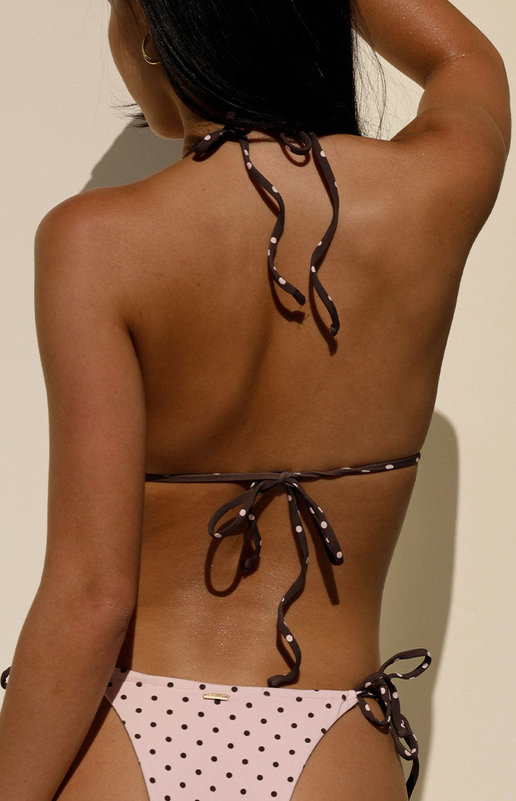 Close-up rear view of the dark brown and pink polka dot bikini top with tied halter neck and back straps