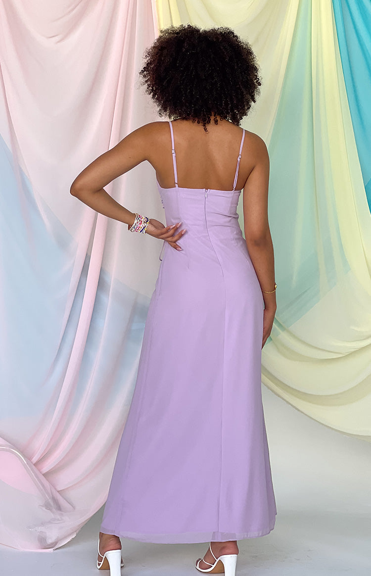 Back of girl in lilac maxi dress and white heels. 