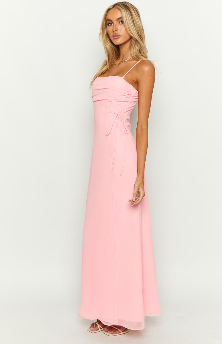 Side view of a pink sleeveless maxi dress with a square neckline, ruched bodice, and side drawstring ties