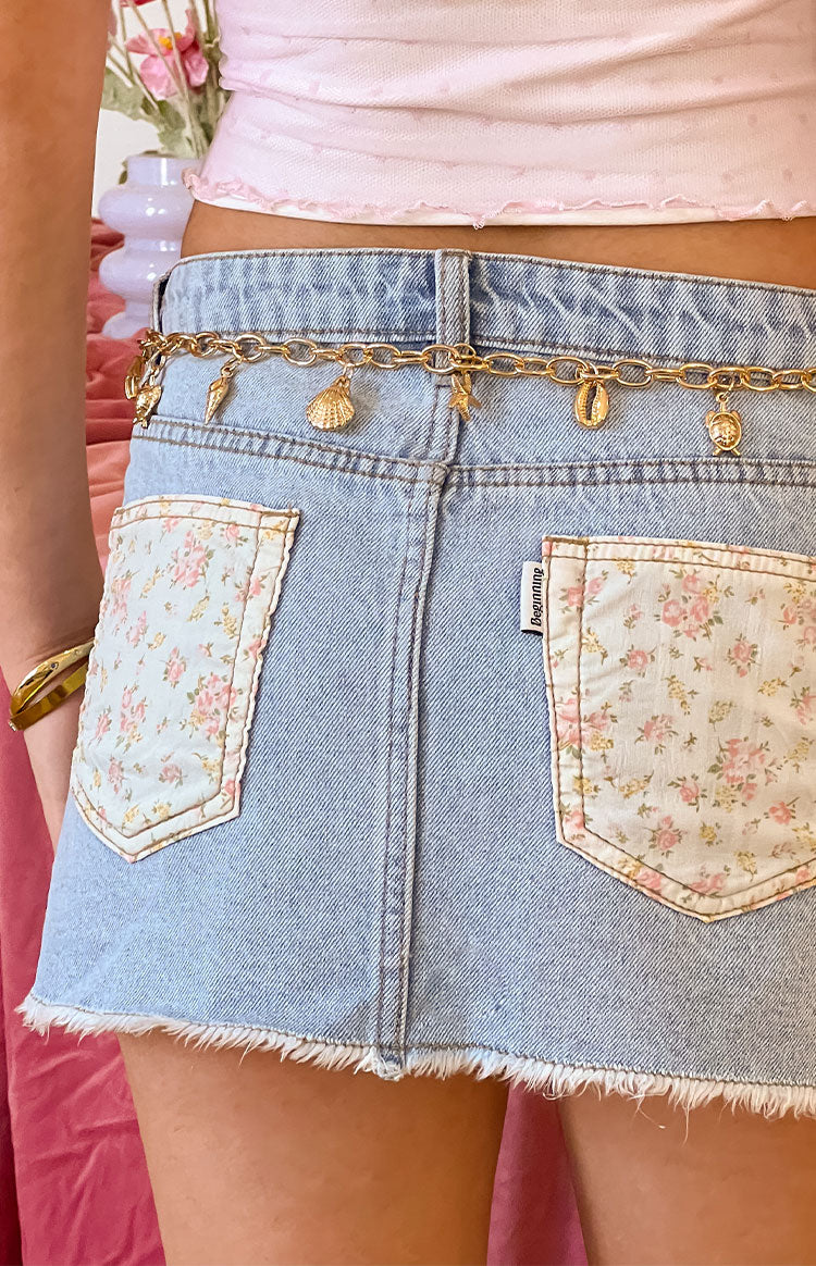 Beginning Boutique Found Love Floral Light Wash Denim Skirt light wash denim mini skirt with floral patch pockets and frayed hem