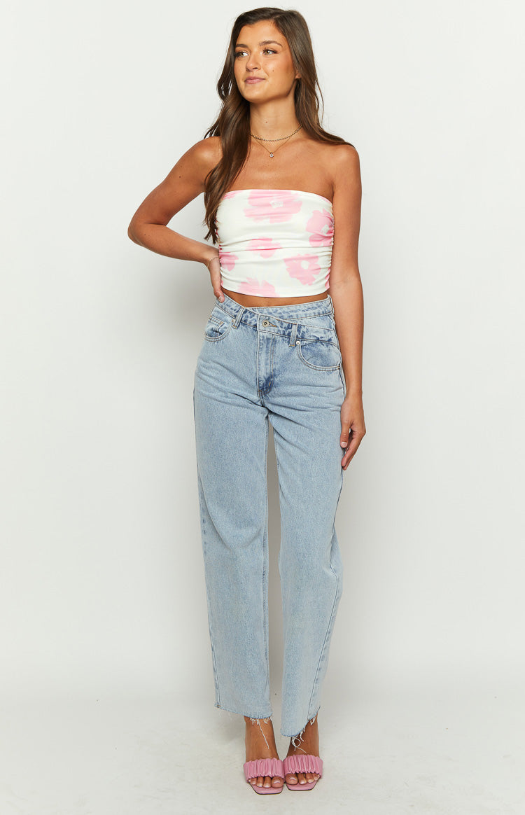 Front view of the white strapless crop top with pink floral print, featuring a fitted silhouette and ruched side seams