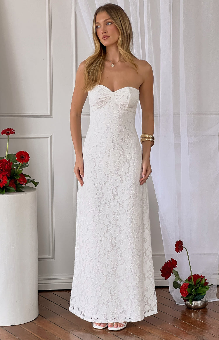 Front view of a white lace strapless maxi dress with a sweetheart neckline and bow detail