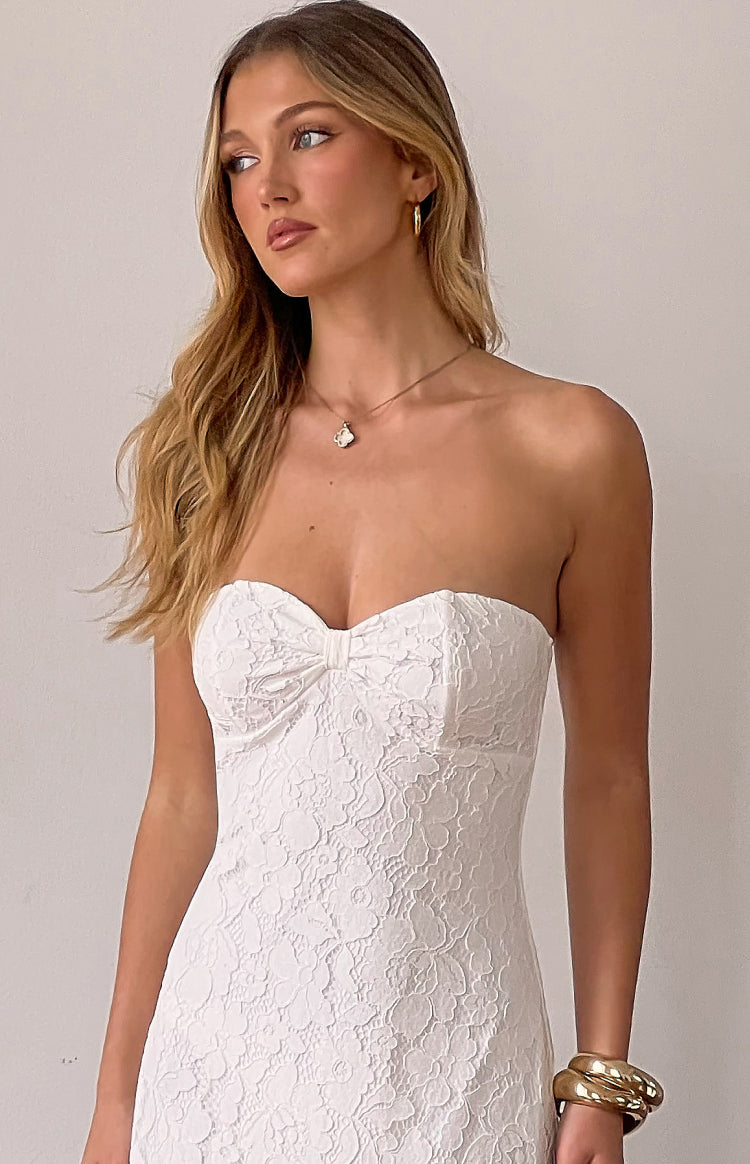 Detail shot of the white lace strapless maxi dress with a sweetheart neckline and bow