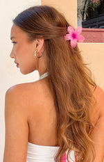Side view of a translucent pink frangipani flower clip with a darker pink center