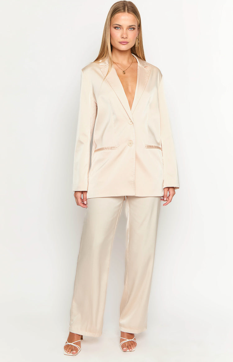 Full length view of cream satin wide-leg pants with a relaxed fit and a smooth, flowing drape