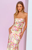 Back view of the yellow floral top featuring an elasticated band across the upper back and a deep open cut-out
