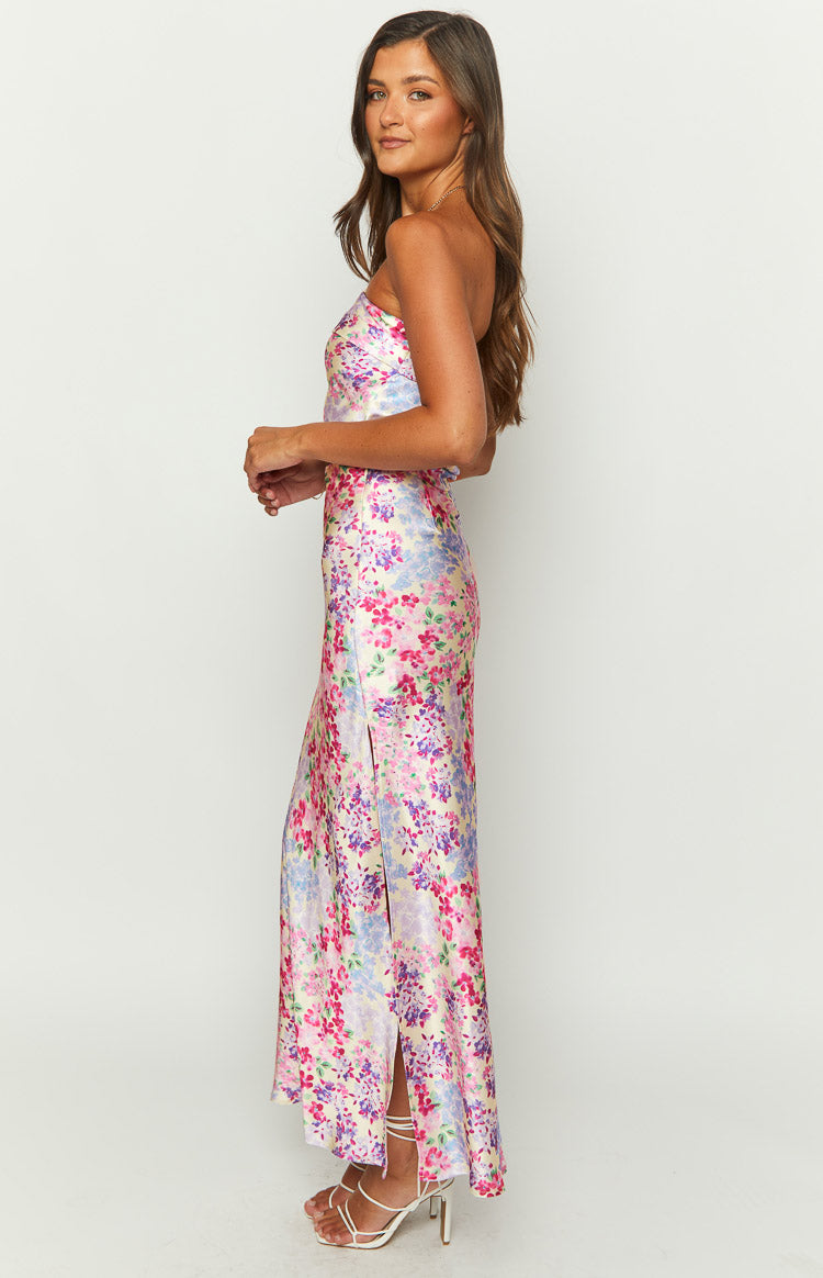 Side view of a pink and purple floral print maxi skirt showing the high side slit