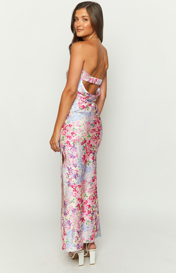 Side view of a satin pink, purple, and blue floral print maxi skirt with a high side split
