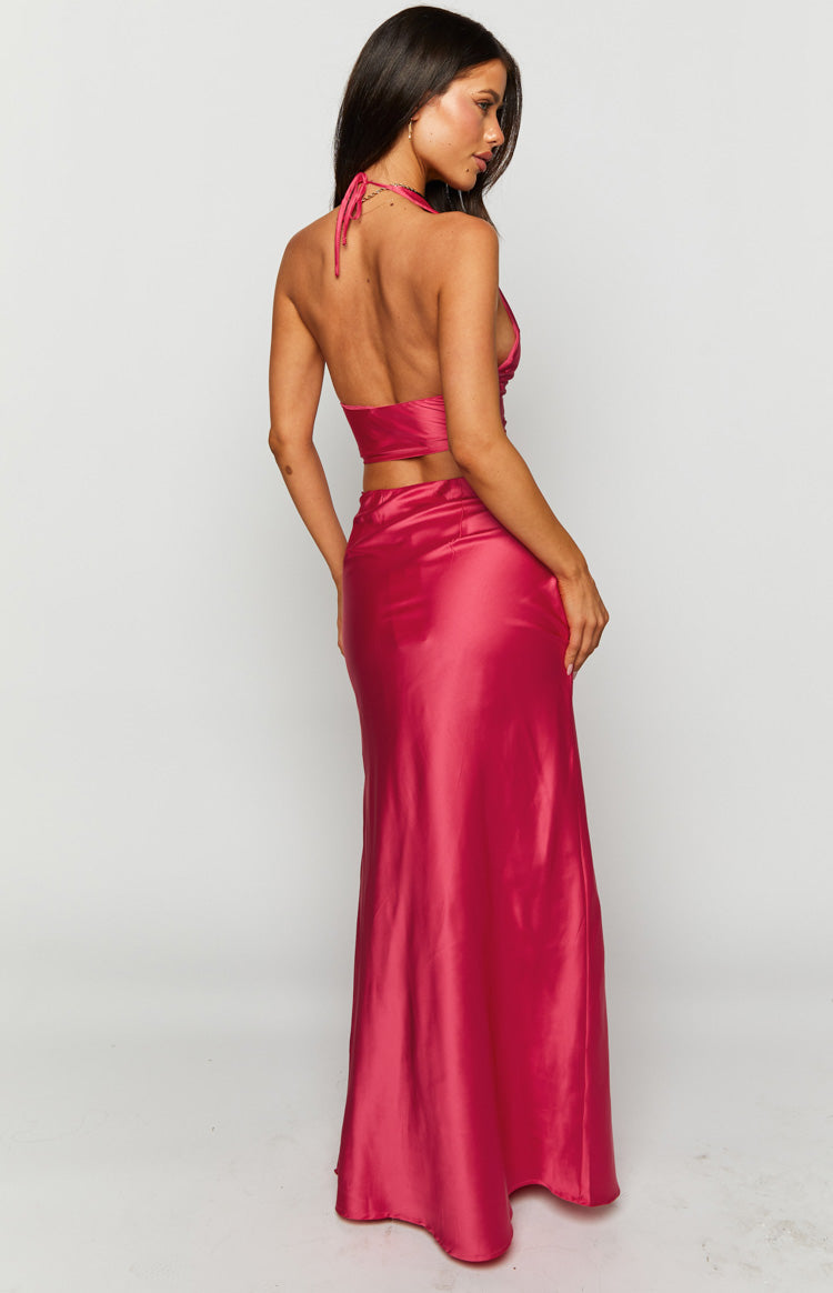 Rear-side view of a pink satin maxi skirt showing its smooth fabric and long, flowing silhouette