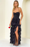 Black maxi dress featuring a ruched sweetheart neckline, tiered ruffle skirt, and a high thigh split