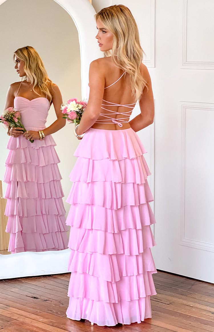 Back view of a pink maxi dress with a criss-cross lace-up back and full tiered ruffles