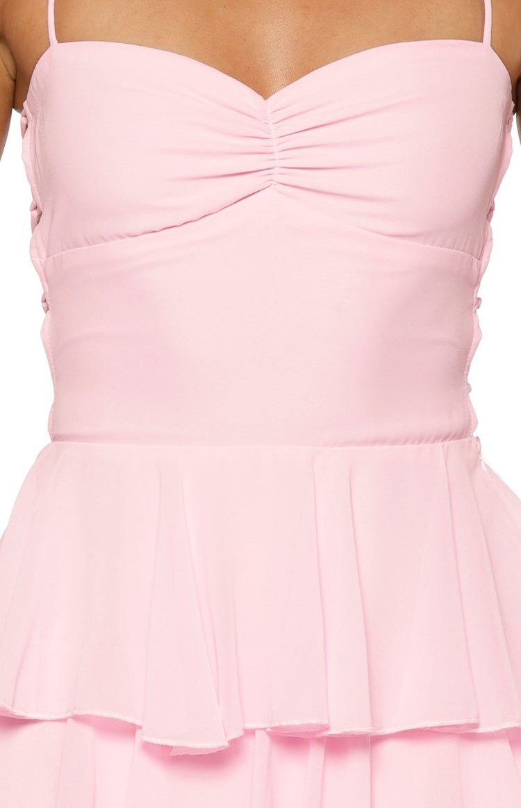 Pink maxi dress close-up highlighting the ruched bust, fitted waist, and delicate tiered ruffles