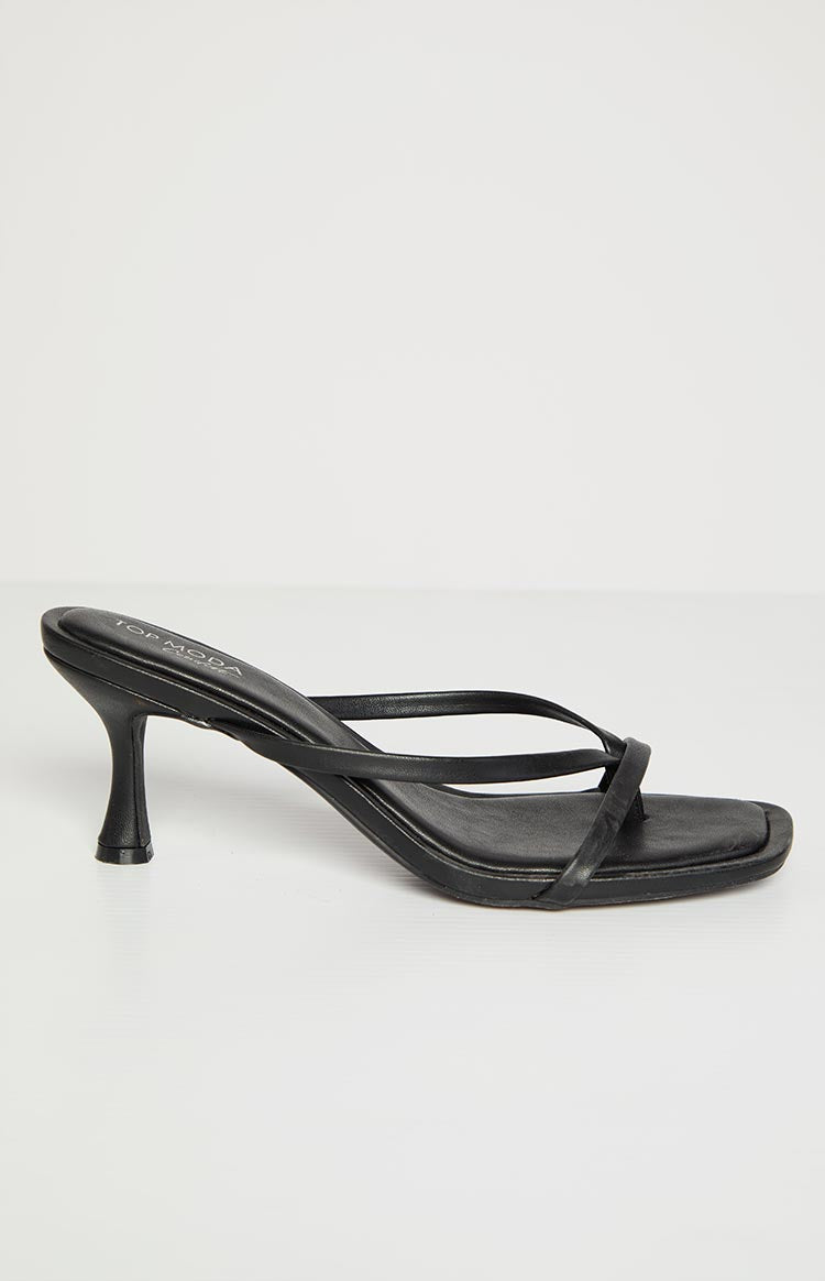 Side view of black kitten heels featuring a slender flared kitten heel and square toe