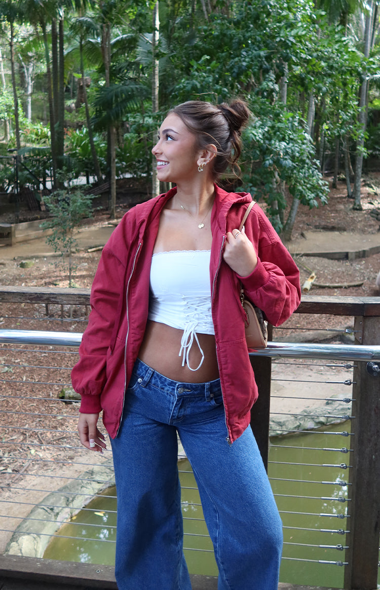 Mid wash denim low rise jeans with a relaxed wide leg fit and visible button closure