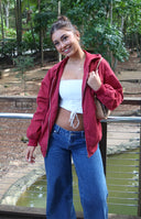 Mid wash denim low rise jeans with a relaxed wide leg fit and visible button closure