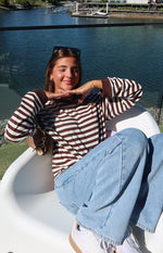 Chocolate and white stripe long sleeve top with a high neckline and ribbed brown cuffs