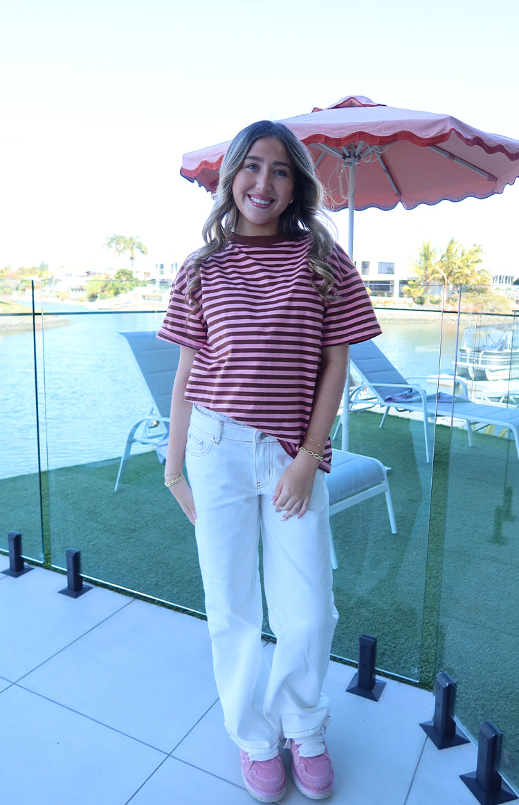 Front view of the pink and brown striped oversized tee with a round neck and relaxed short sleeves